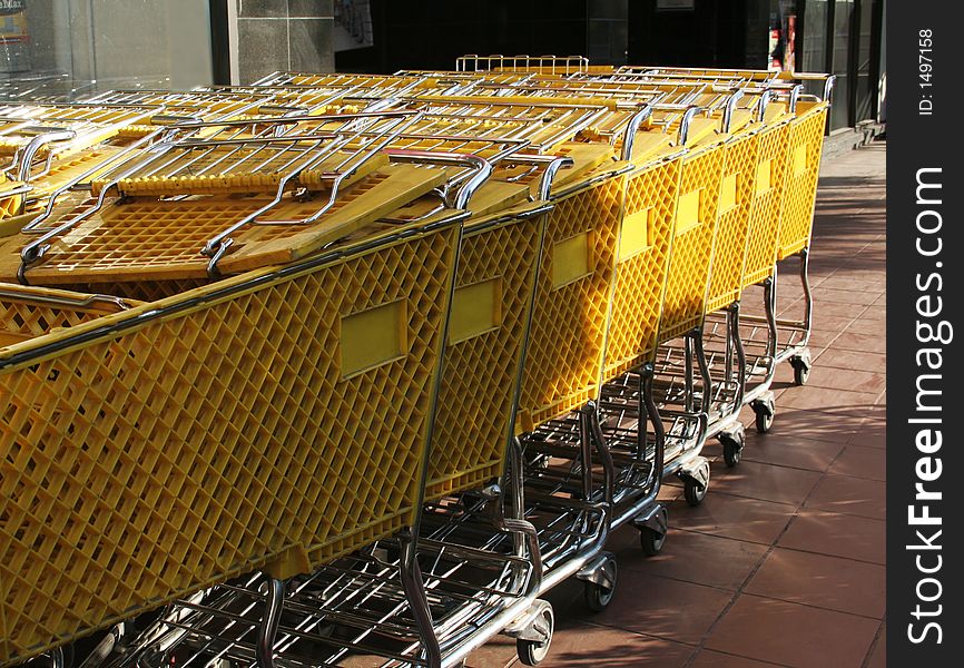 A row of yellow shopping carts