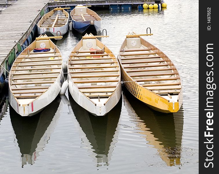 Group of similar boats for hire at a marina. Group of similar boats for hire at a marina.