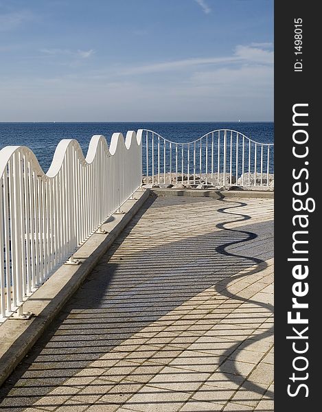 Repetitious, wavy metal railing on the shore of one of the Great lakes. Repetitious, wavy metal railing on the shore of one of the Great lakes