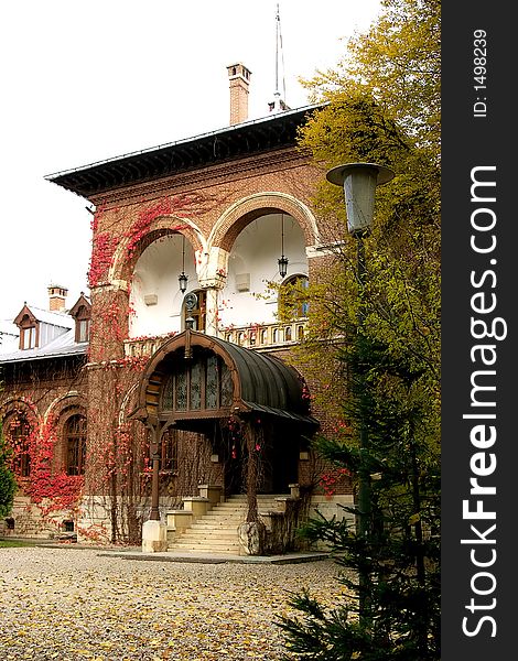 Dream old house with red ivy on the walls in Curtea de Arges Monastery park - Romania. An imppresive relgious monument finished in 7 january 1517 by Neagoe Basarab