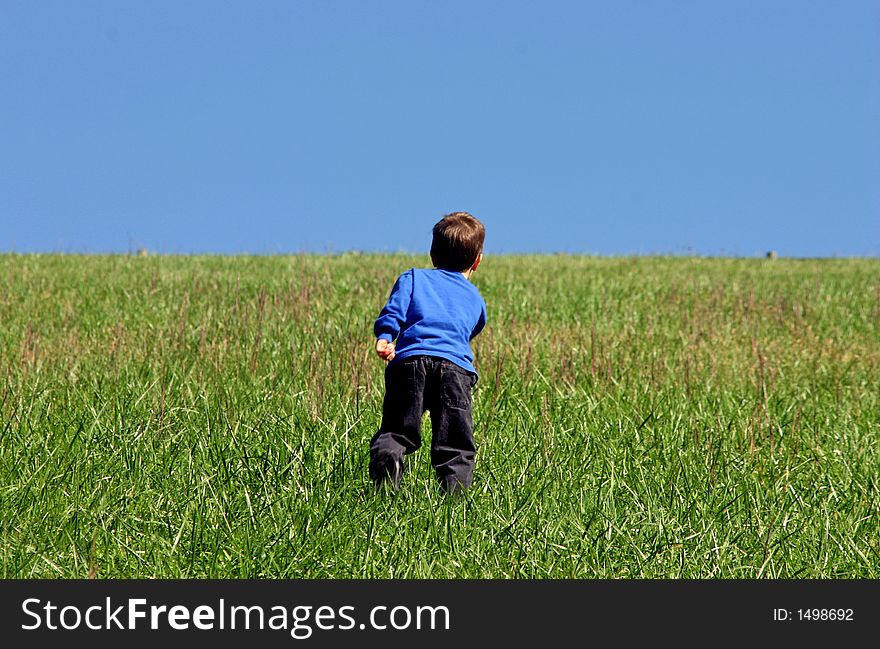 Boy Climbing A Hill