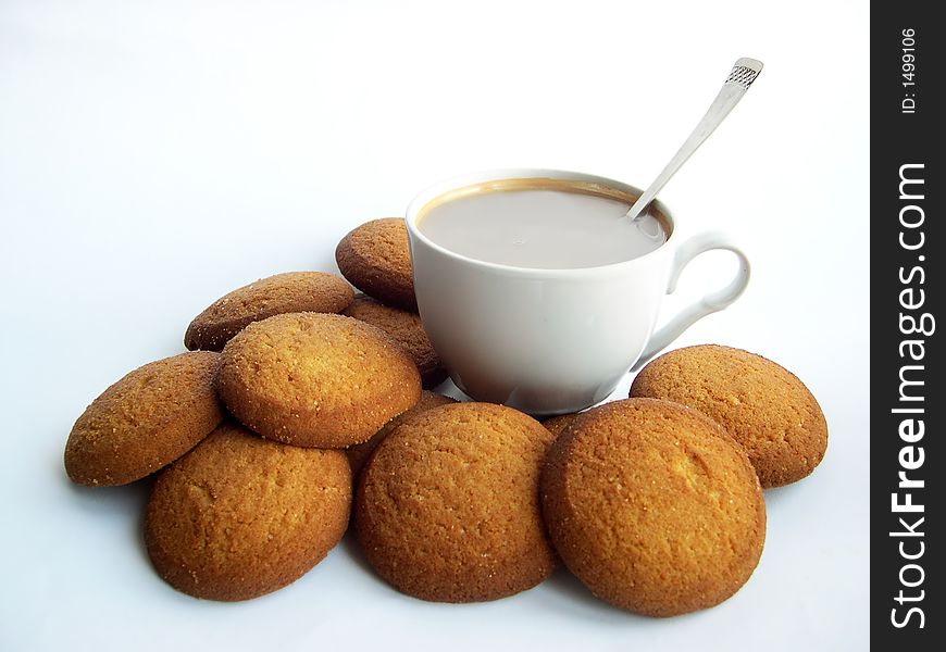 Mug of coffee on a white background with tasty cookies