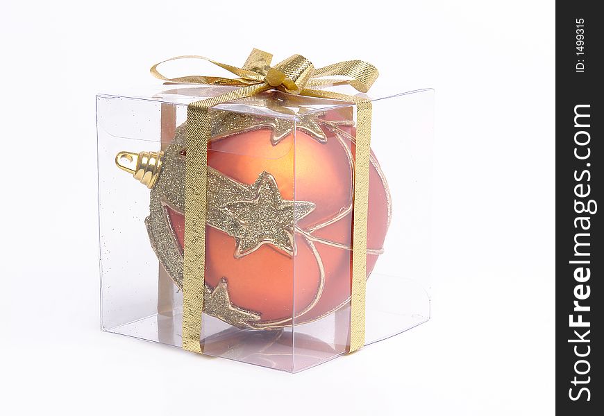 Christmas ball packed in transparent box over white background. Christmas ball packed in transparent box over white background