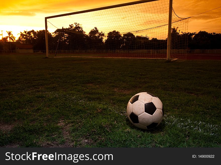 One football on the ground with sunset. One football on the ground with sunset