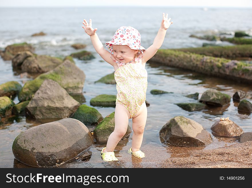 Image of the happy baby playing on the beach
