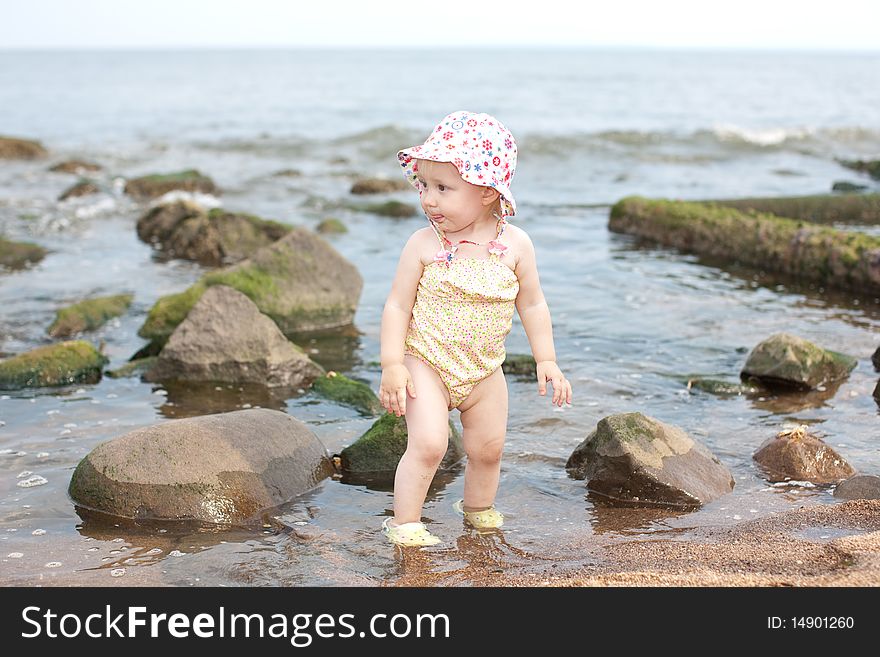 Image of the happy baby on the beach
