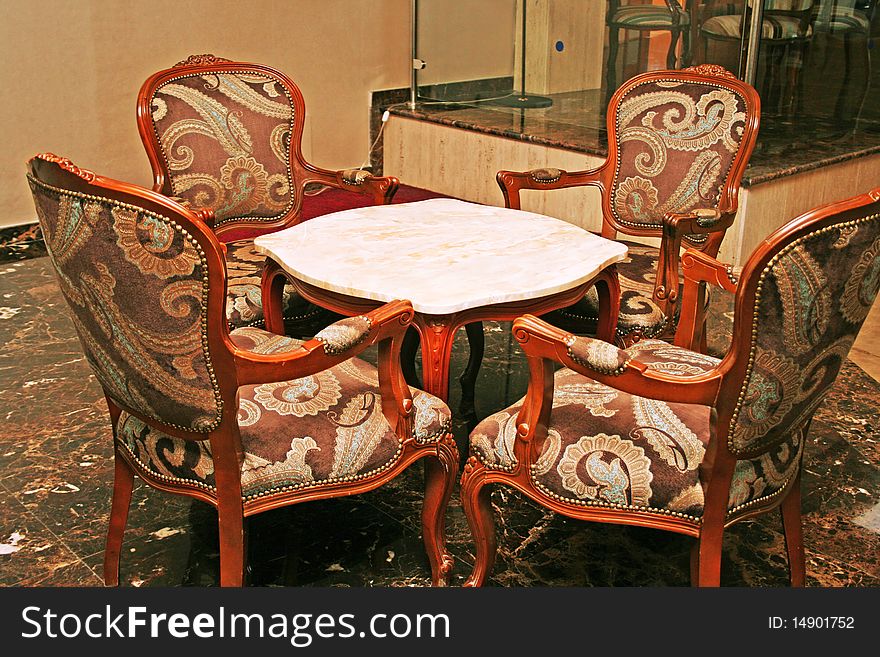 Marble table and luxurious armchairs. Marble table and luxurious armchairs.