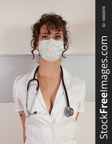 Young female doctor wearing surgical mask and stethoscope