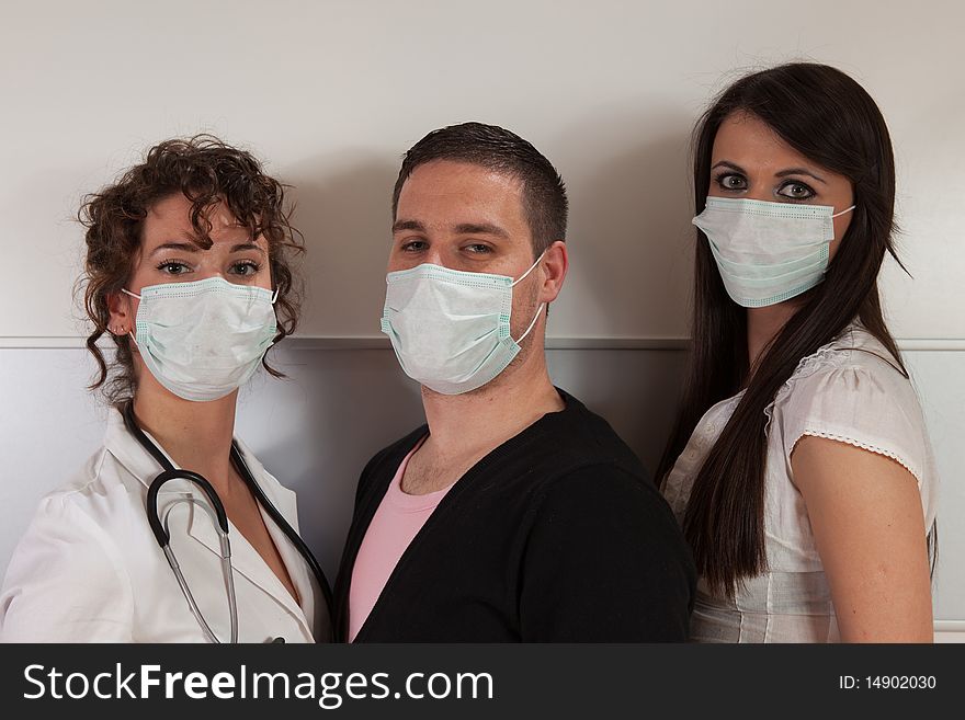 Group of three young people wearing surgical masks. Group of three young people wearing surgical masks