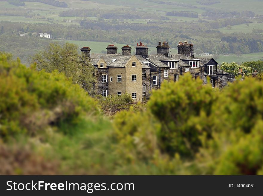 English countryside landscape: house behind bushes