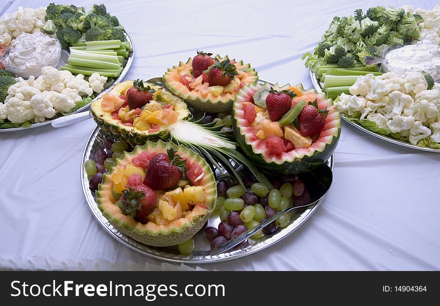 Fruit tray with carved fruit and partial vegetable trays. Fruit tray with carved fruit and partial vegetable trays