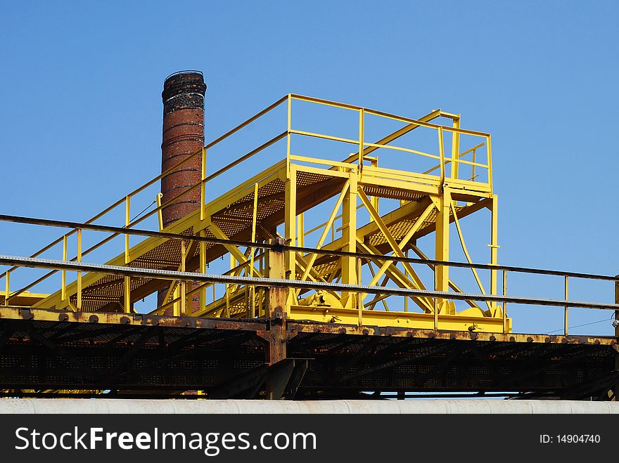 Gantry crane against blue sky background