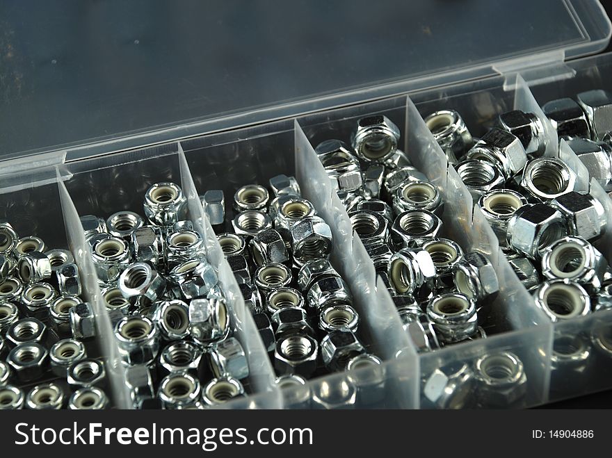 Box containing several nuts and washers of different sizes. Box containing several nuts and washers of different sizes