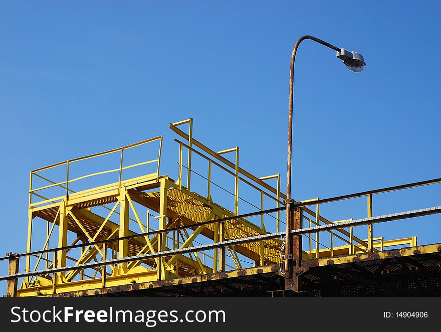 Gantry crane against blue sky background