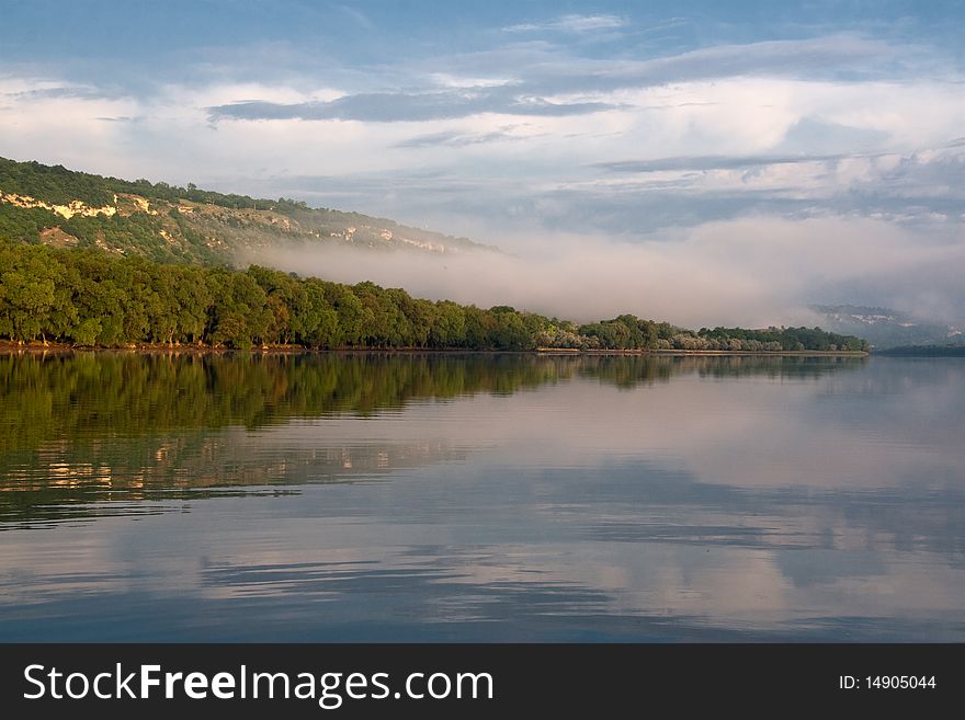 In a river landscape with nature morning with fog