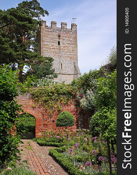 An English Walled Garden And Church Tower