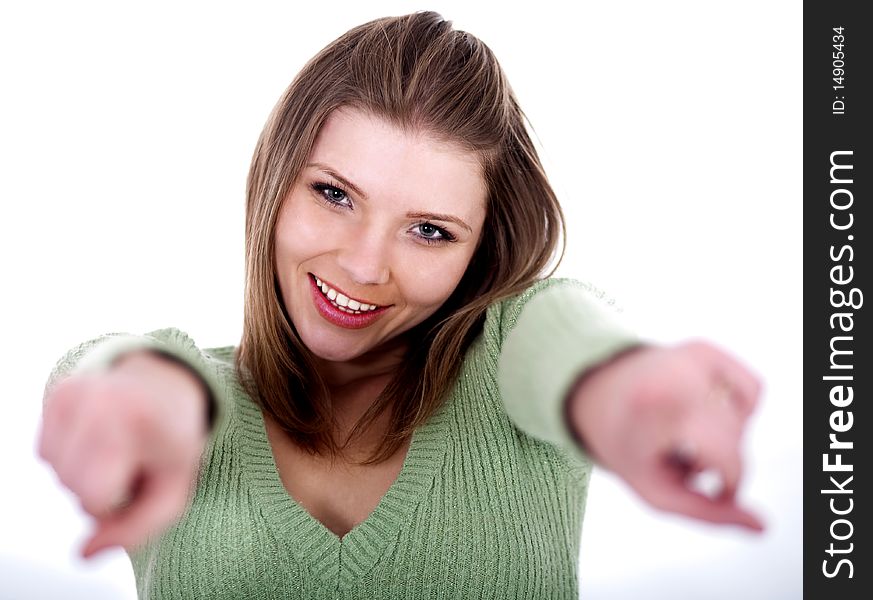 Smiling young female pointing through her both hands on a isolated white background