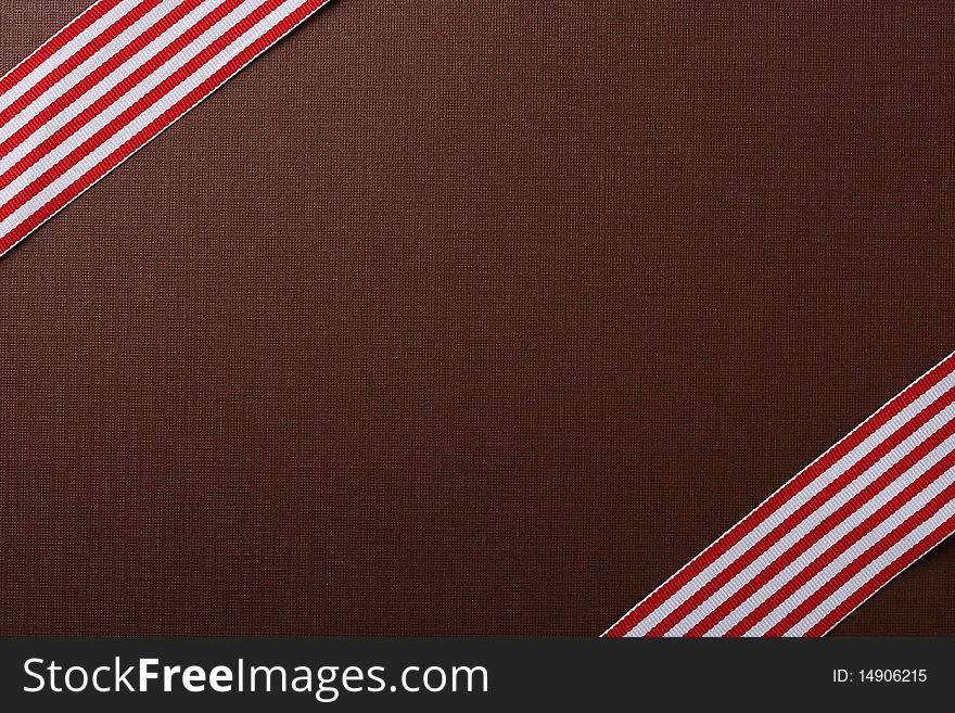 Brown background with two red-white tapes for design works.
