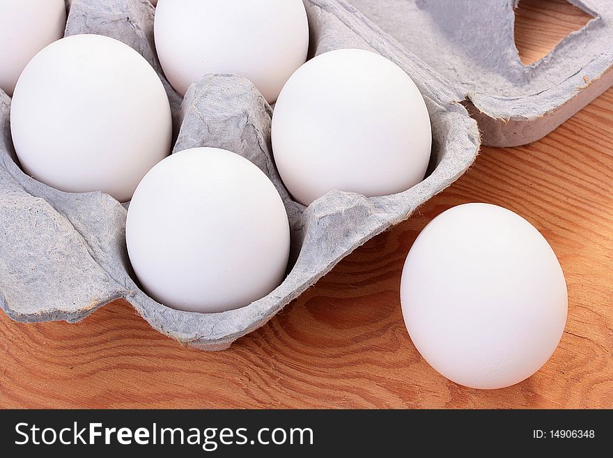 Eggs of white colour are combined in a special tray for transportation and sale.