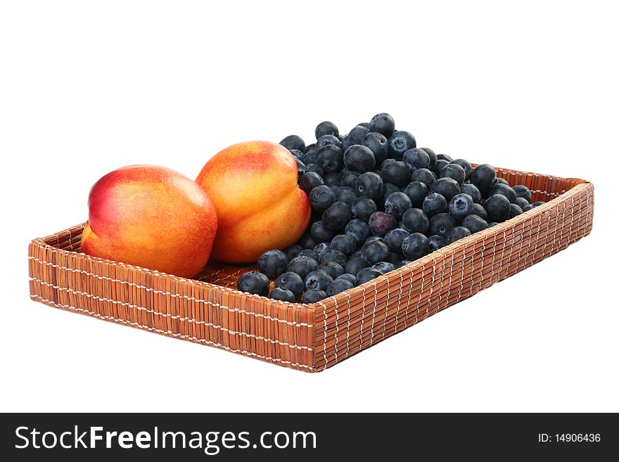 Berries of a blueberry and nectarine in a deep wattled tray. Berries of a blueberry and nectarine in a deep wattled tray.