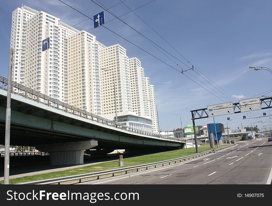 Urban scene with highway overpass and skyscraper building