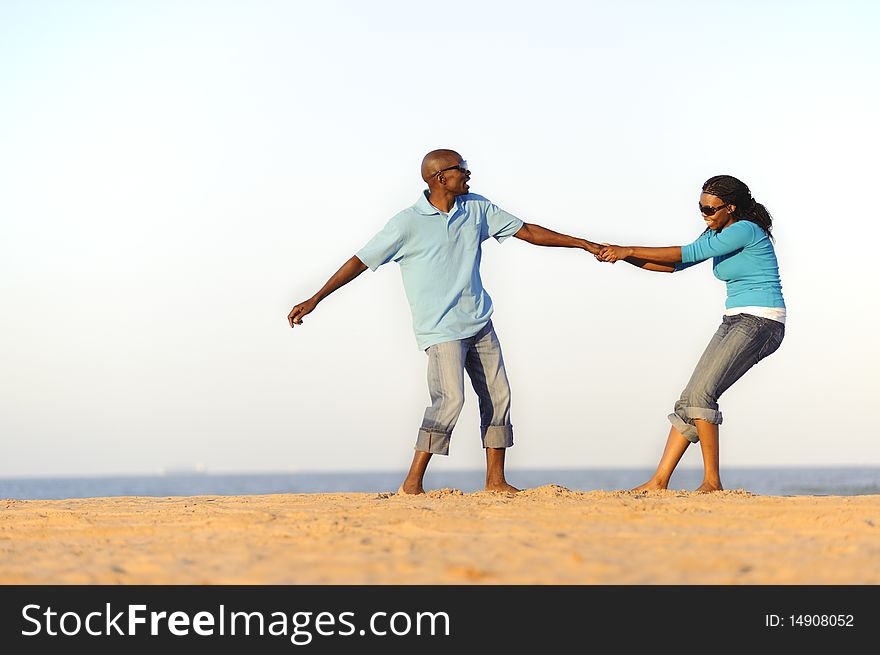 African American couple hand in hand on the beach. African American couple hand in hand on the beach