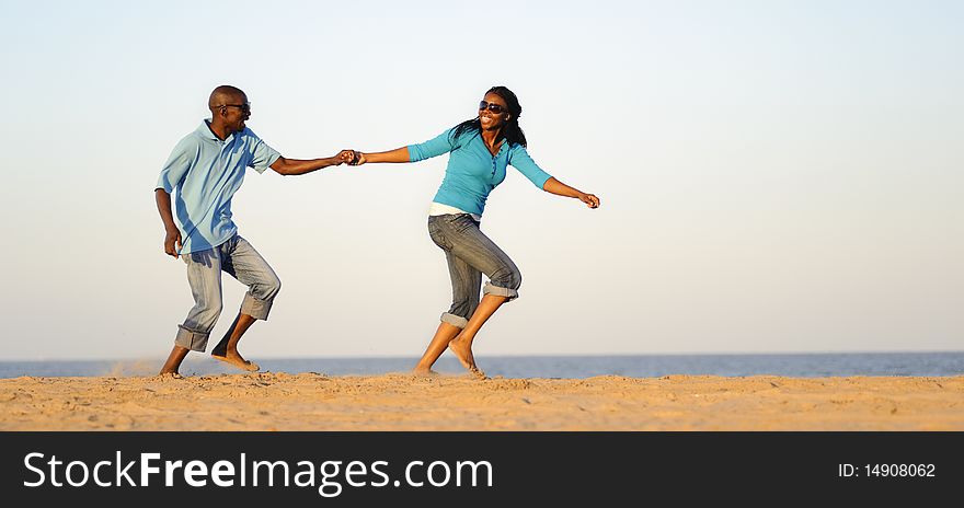 African American couple hand in hand on the beach. African American couple hand in hand on the beach