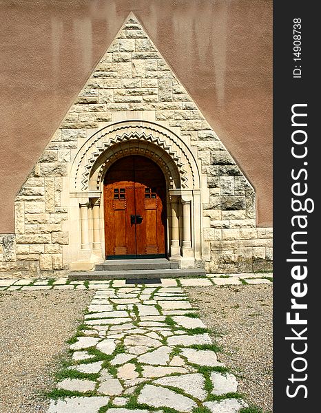 Old elegant vintage door entrance with stone pathway