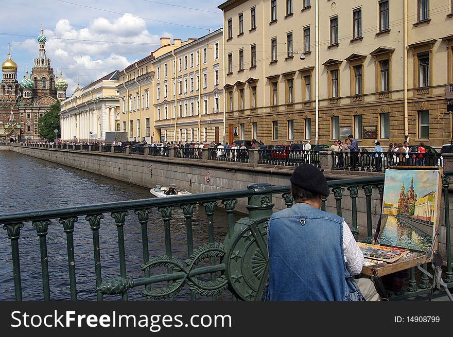 Street artist painting on a bridge of Saint-Petersburg the church of Resurrection of the Lord. Street artist painting on a bridge of Saint-Petersburg the church of Resurrection of the Lord.