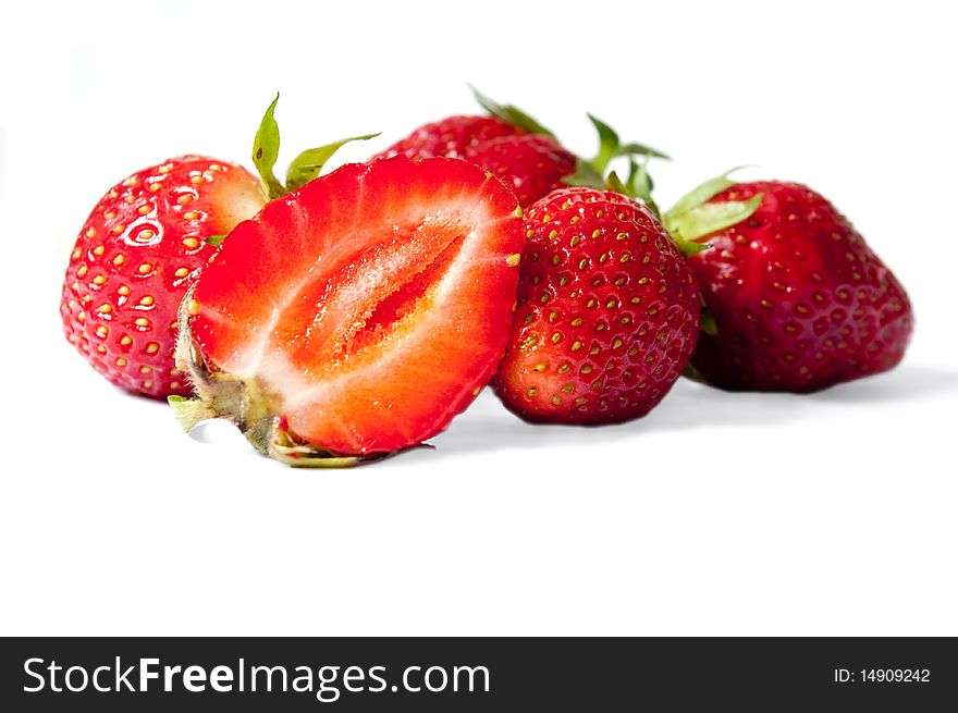 Some strawberries, with a half, with a shade on a white background. Some strawberries, with a half, with a shade on a white background