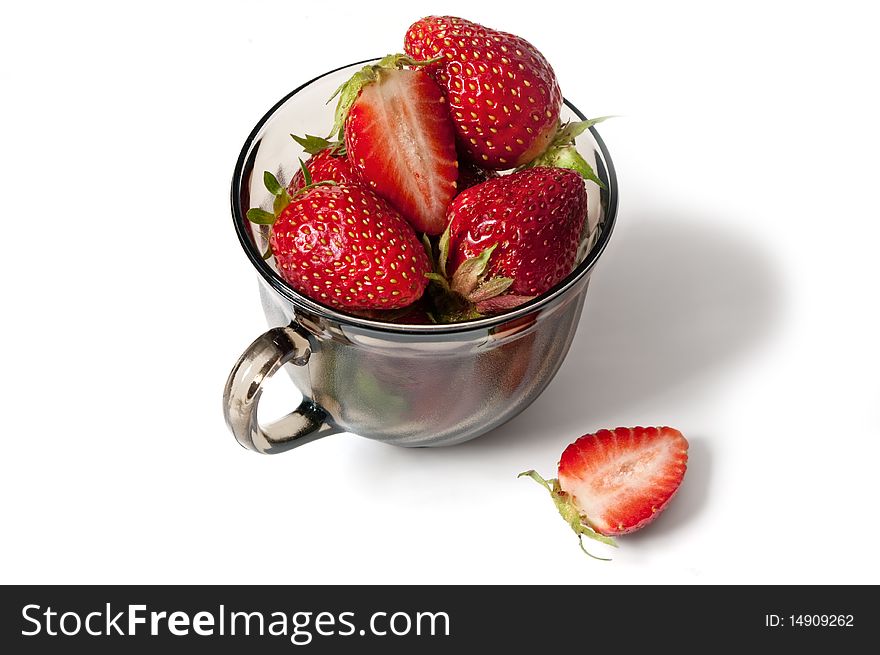 Ripe strawberry in a black cup with a shade on a white background. Ripe strawberry in a black cup with a shade on a white background