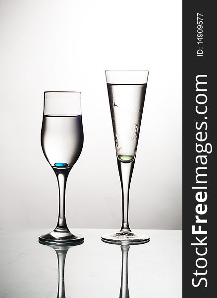 Two glasses on glass table water