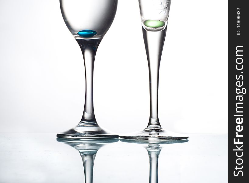 Two glasses on glass table