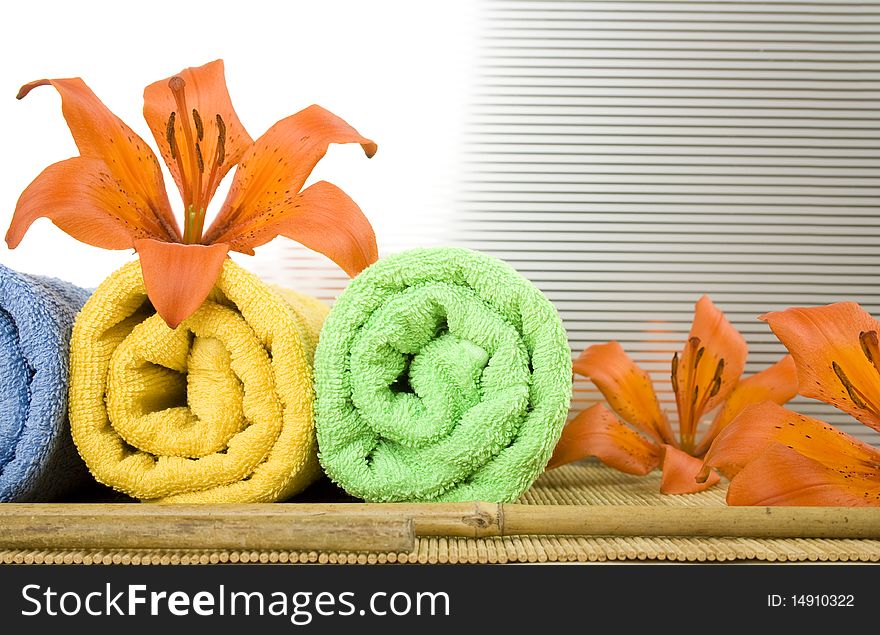 Colored towels are folded to lie next to them flower tiger lily. Colored towels are folded to lie next to them flower tiger lily