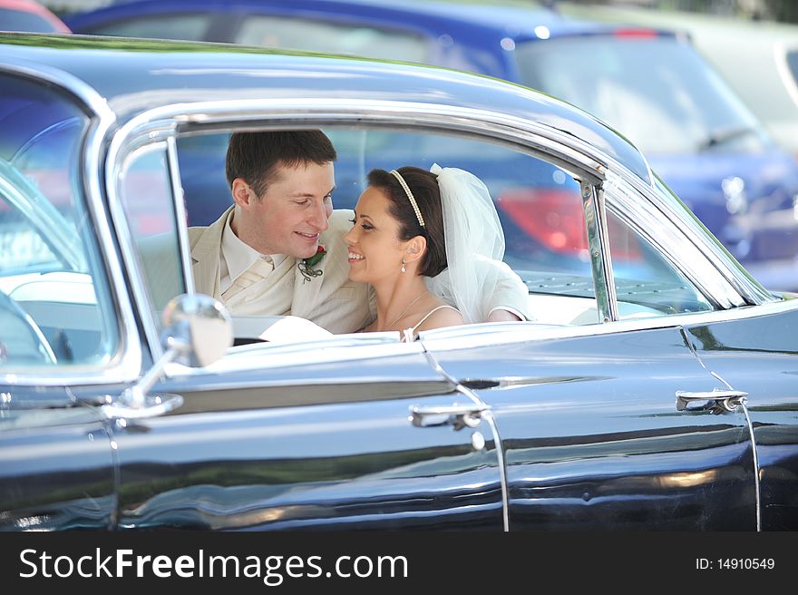 Newlywed couple, groom and bride, in car. Newlywed couple, groom and bride, in car
