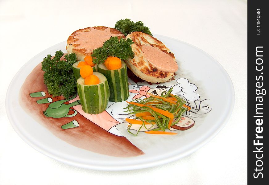 The zucchini's pancake under vegetable sause with pieces of fresh cucumber, carrot's ball and greenery on the white plate with drawing. It is slight snack without calorie. The zucchini's pancake under vegetable sause with pieces of fresh cucumber, carrot's ball and greenery on the white plate with drawing. It is slight snack without calorie.