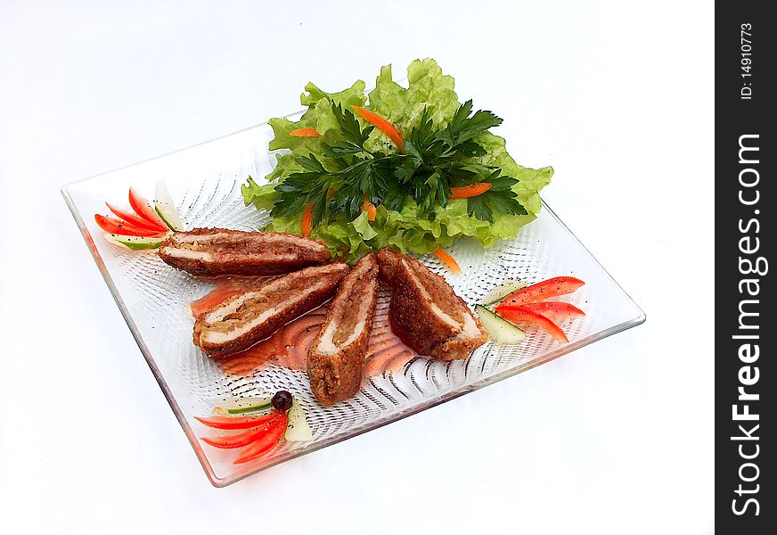 The glass plate of pork with onions - apple confiture. Around pieces of meat the slices of vegetables are beautifully stacked. The glass plate of pork with onions - apple confiture. Around pieces of meat the slices of vegetables are beautifully stacked.
