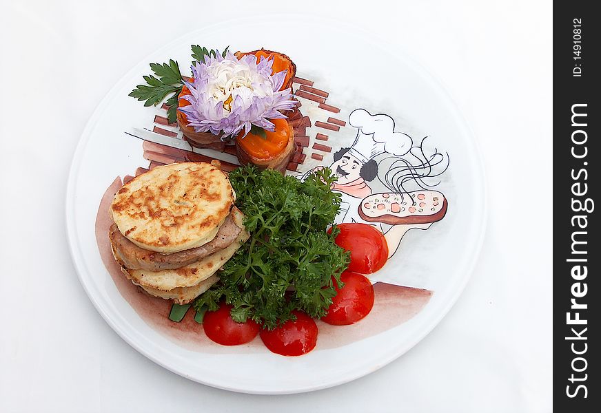 The ornament plate with medallions from pork with flat cakes from vegetable marrow under teriyaki sauce. The ornament plate with medallions from pork with flat cakes from vegetable marrow under teriyaki sauce.