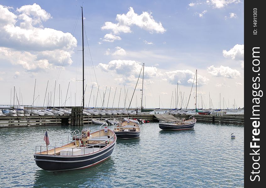 This is an image of tender boats owned by the city that help service the boats in the marinas along Lake Michigan. This is an image of tender boats owned by the city that help service the boats in the marinas along Lake Michigan.