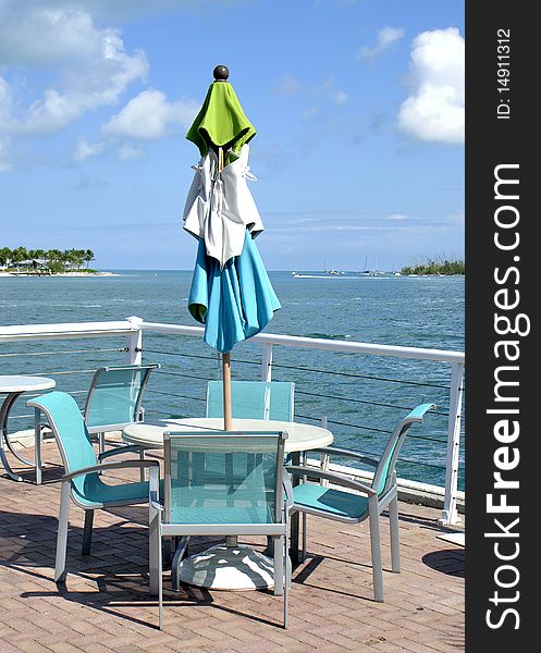 This is an image of a sun umbrella on a deck overlooking the water in Key West, Florida. This is an image of a sun umbrella on a deck overlooking the water in Key West, Florida.