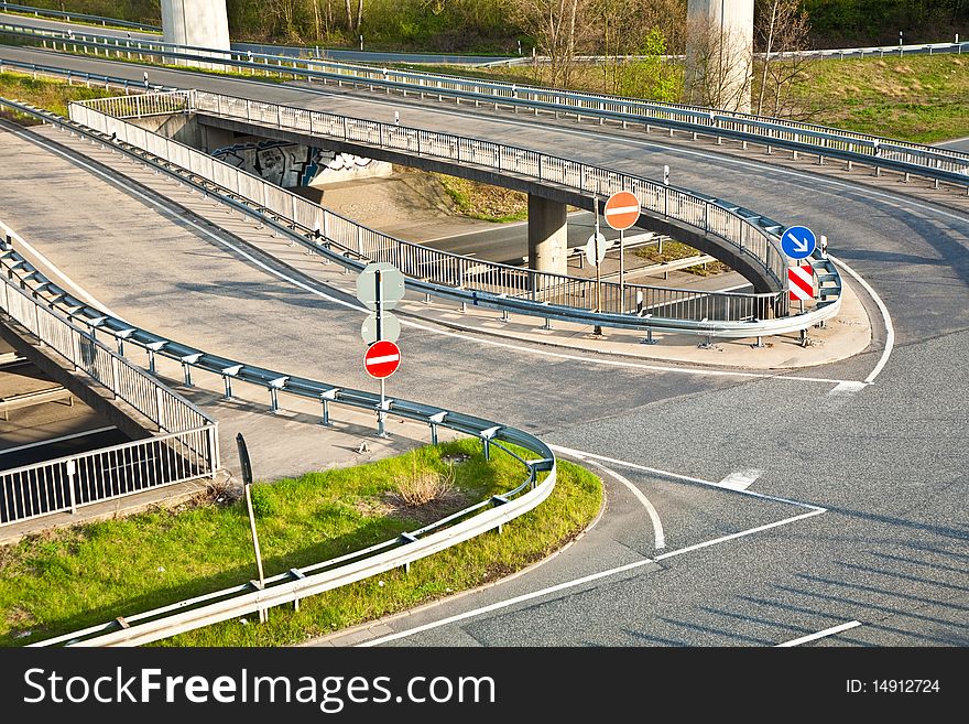 Empty highway with traffic signs in morning light - rush concept