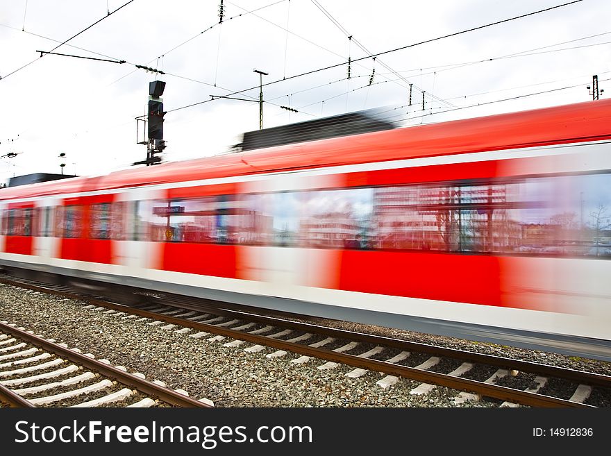 Red Train leaves the station with speed