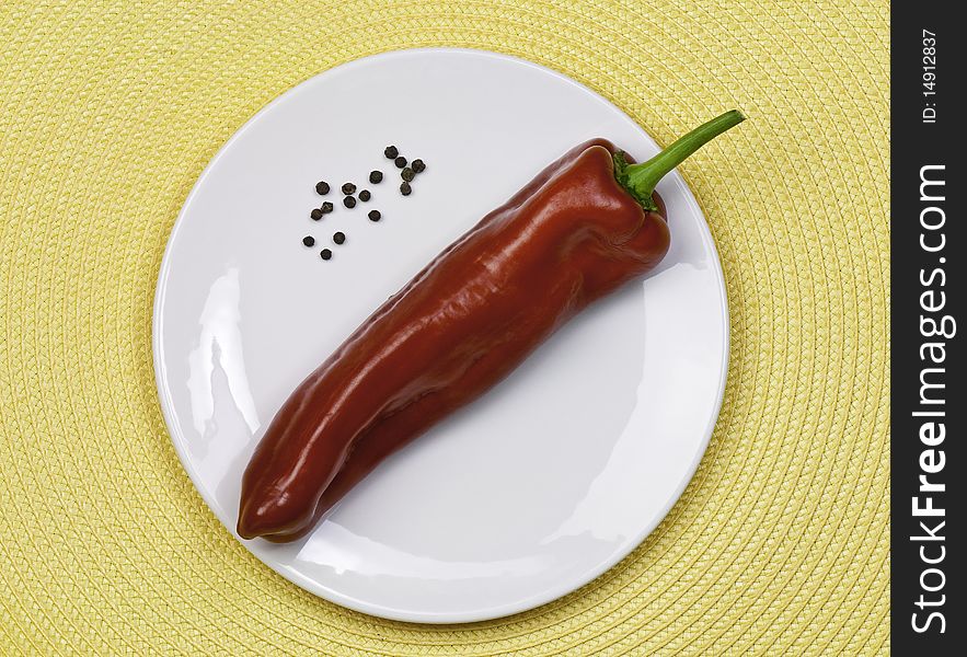 Fresh sweet red pepper on a white plate