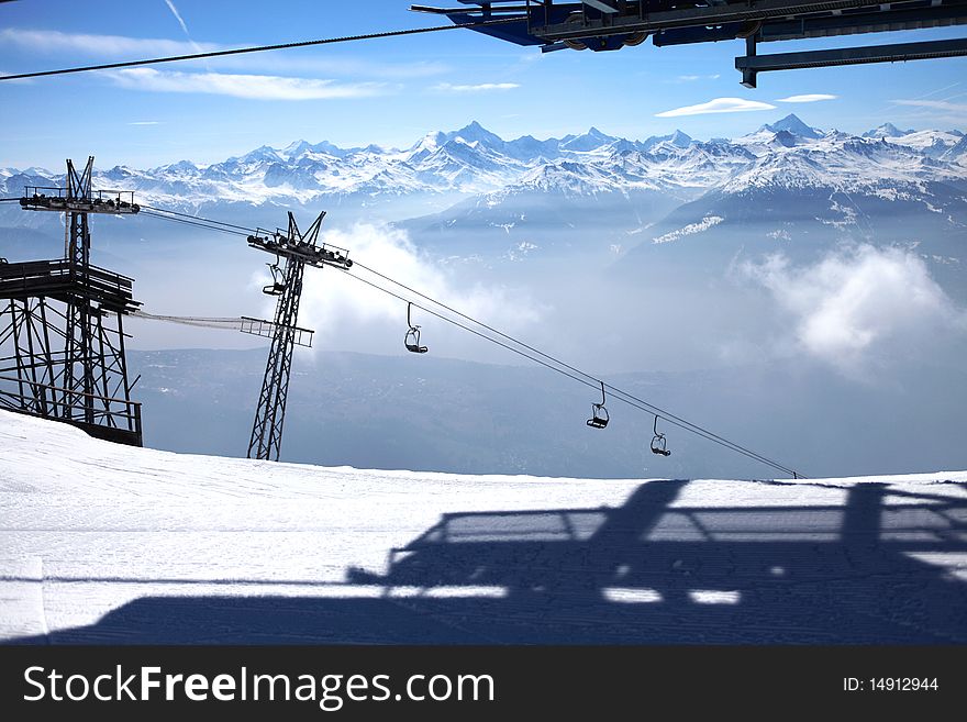 View of swiss mountain lifts and clouds, winter
