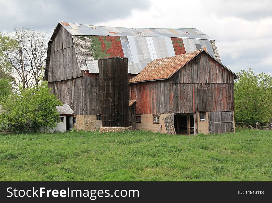 Old barn with roof of many colors