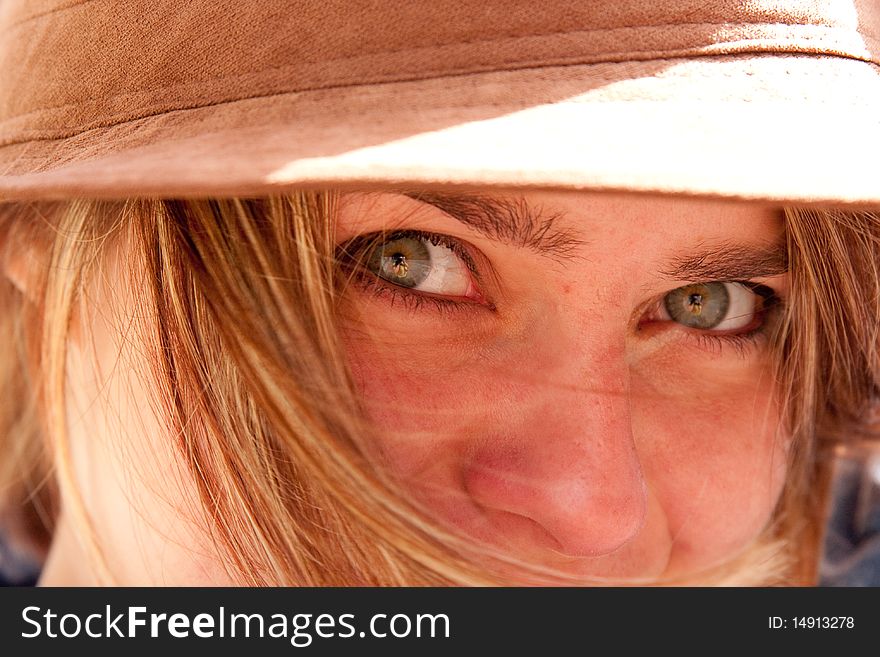 Closeup of green eyes of attractive blonde girl