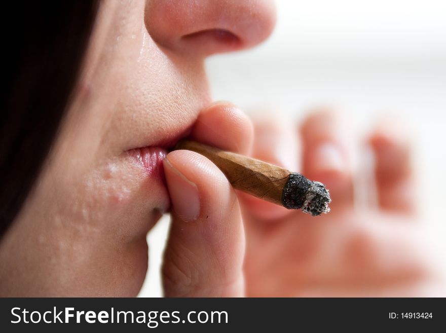 Close-up Of Girl With Smoked Cigar End