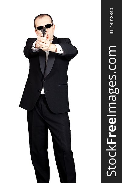 Man in tuxedo with a gun aiming at viewer. Man in tuxedo with a gun aiming at viewer