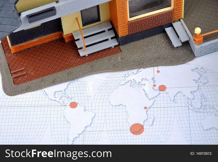 House model and world map, means world wide real estate market, industry and economy situation.