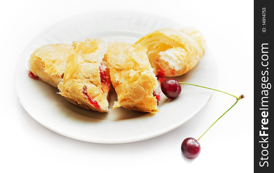 Fresh croissant with cherry as breakfast